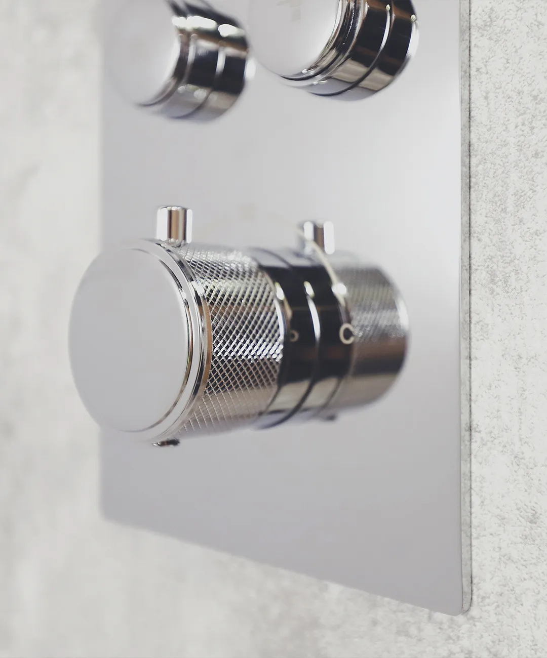 Push-button thermostatic shower valve, operable with a closed fist rather than a twisting grip