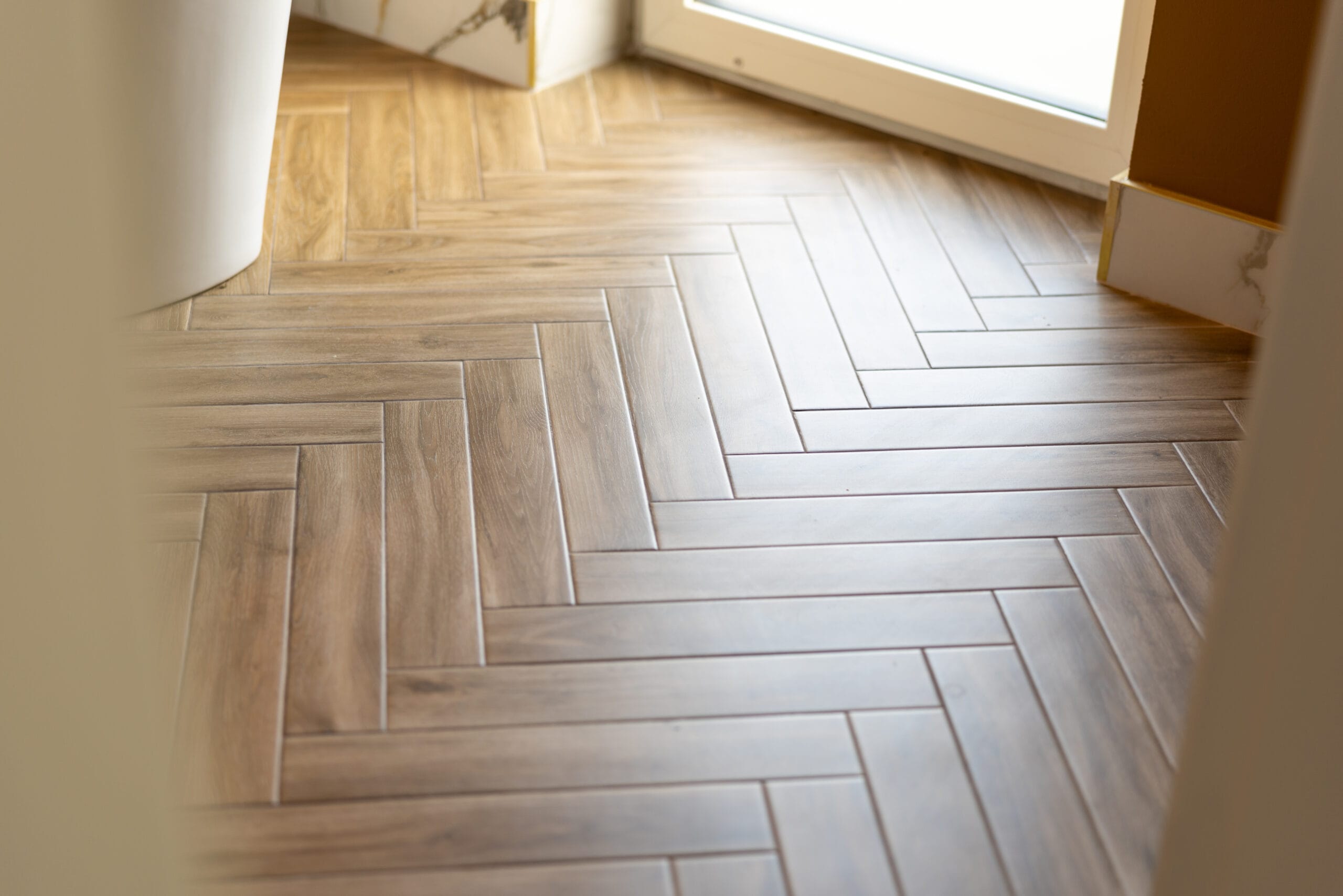 Textured wood-effect porcelain floor tiles in a smaller plank format with defined grout lines