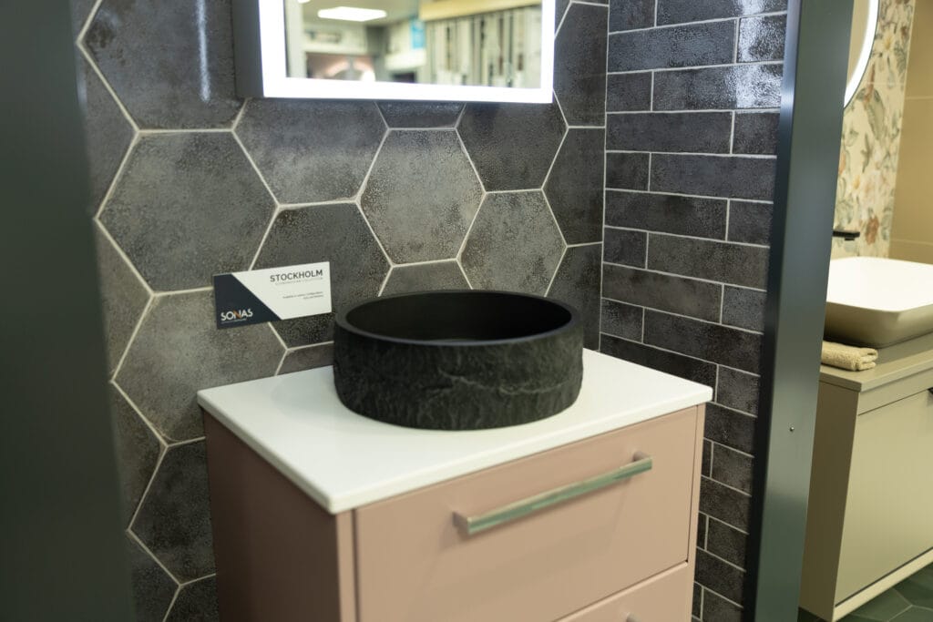 Showroom at miller wholesale showcasing a pink vanity unit & stone sink