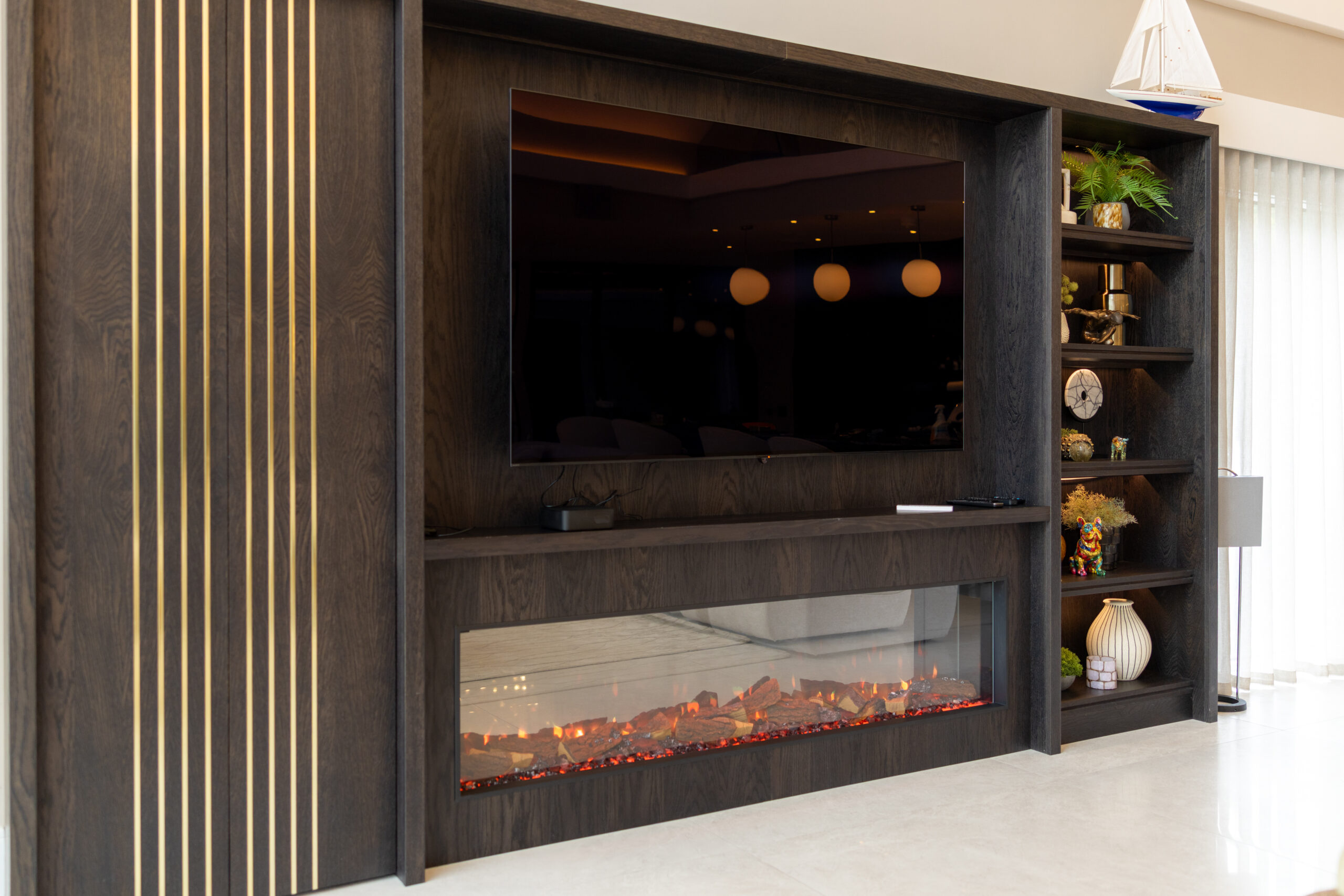 Fireplace feature with stone surround and media wall