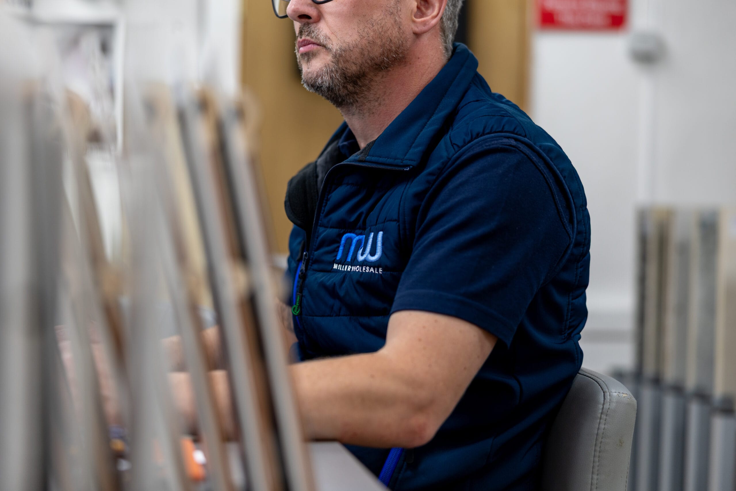 Miller Wholesale team member going through tile samples with a customer in the showroom