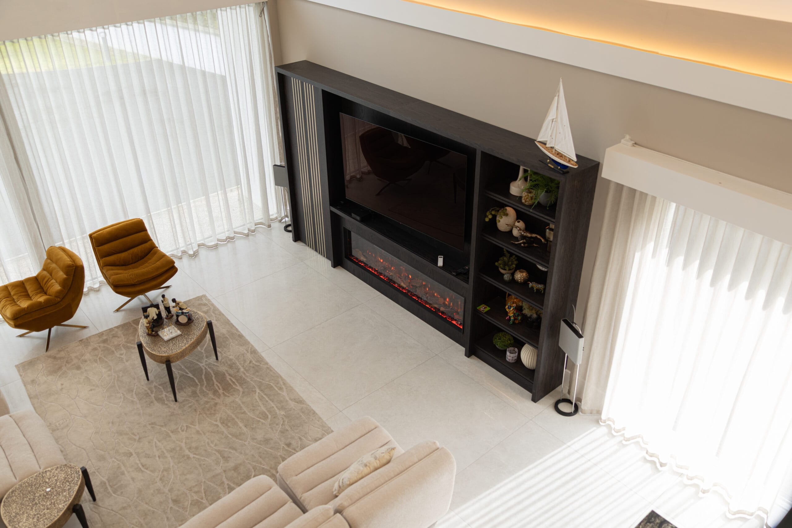 Aerial view luxury living room cream large format floor tiles electric fireplace