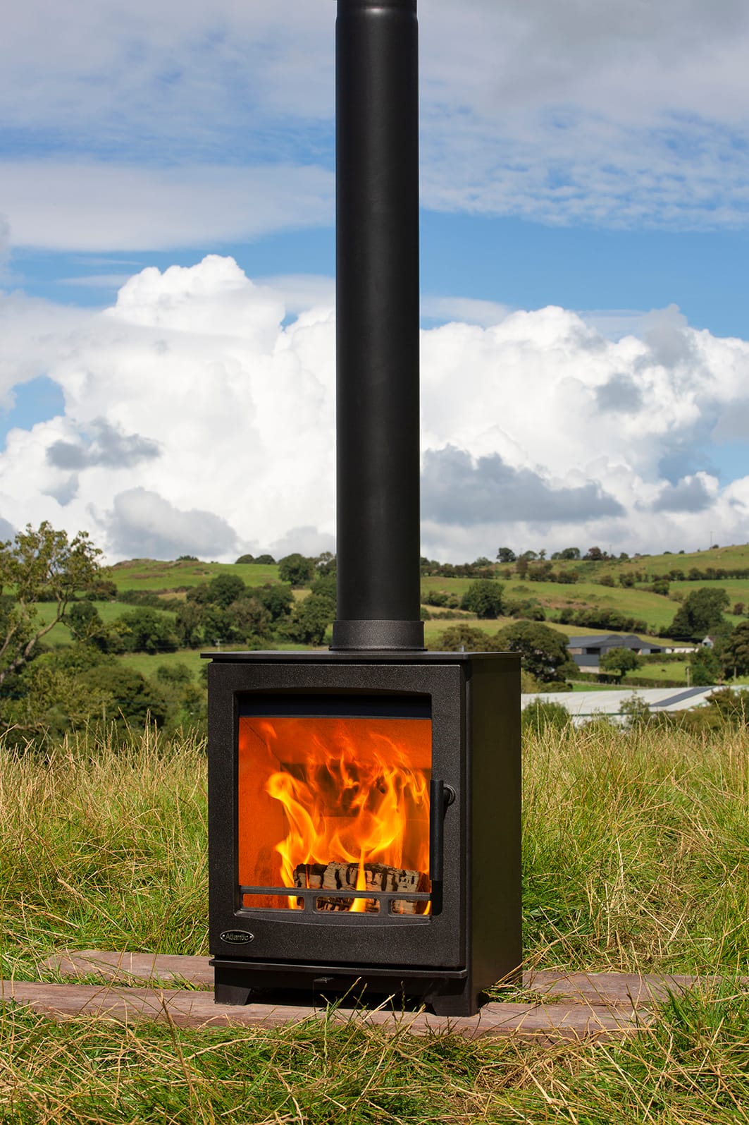 Atlantic Oyster 5 stove with a curved door, lit and photographed outdoors