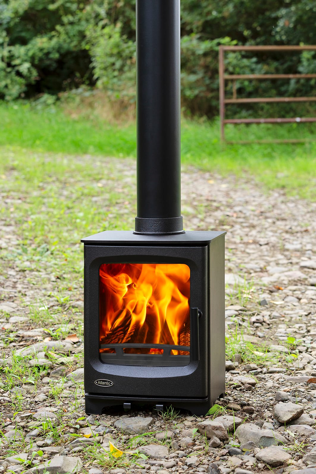 Atlantic Pearl 5 multi-fuel stove with a full fire behind the glass